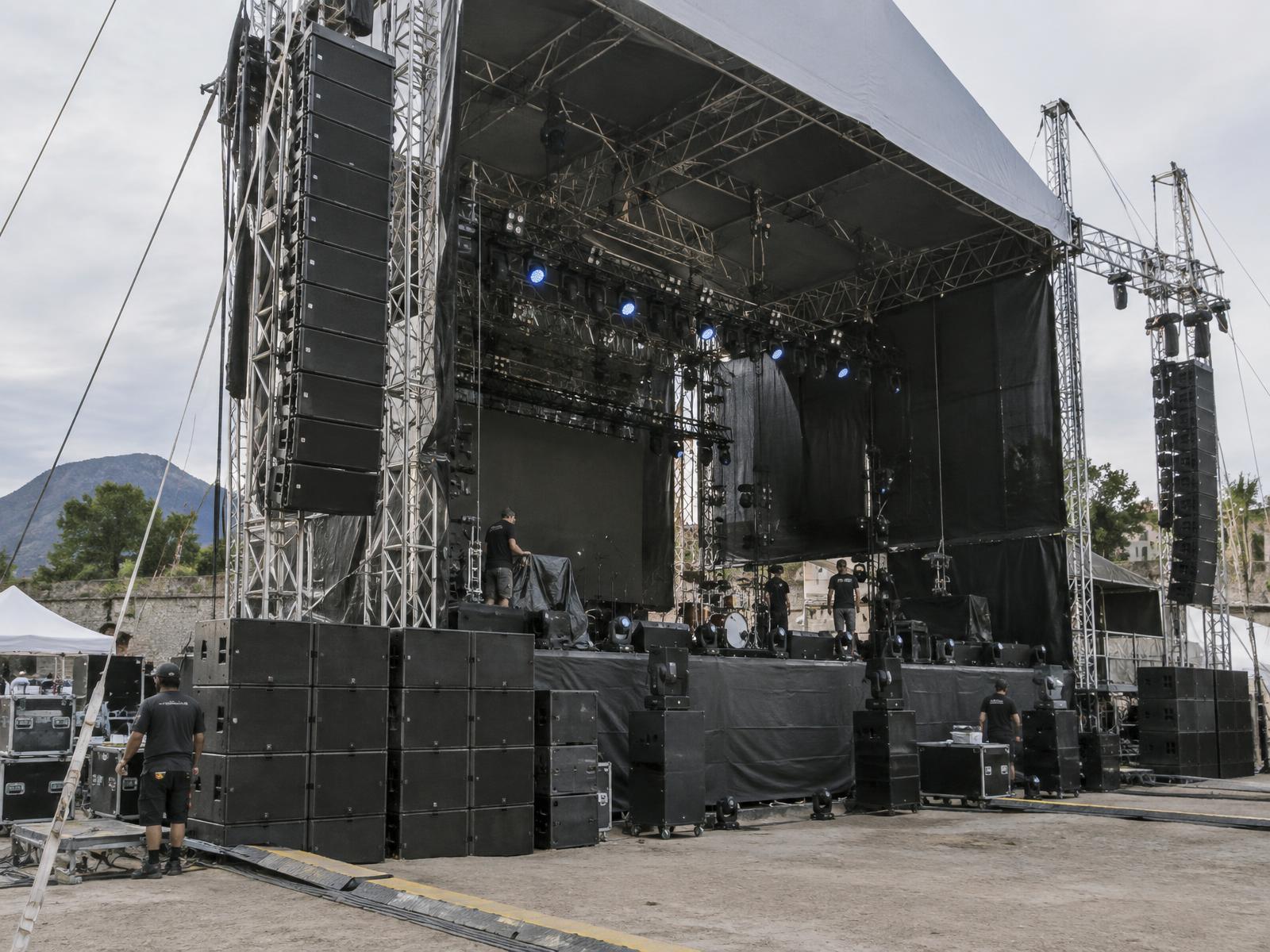 Técnicos instalando un sistema line array para festival